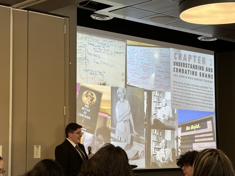 Asa Baker presenting their thesis at the 2024 English Senior Showcase.