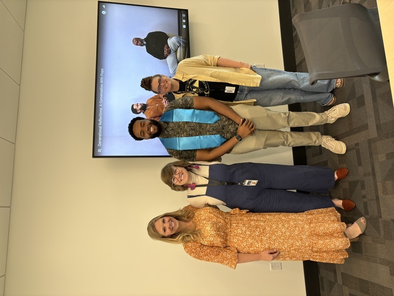 Photograph of Julian Haywood wearing his honors stole, standing with his committee. From left to right: Laura Decker, Molly Appel (advisor), Julian Haywood, Christine Beaudry.