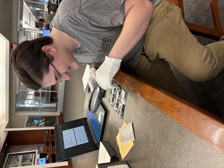 Asa Baker reviews archival material in the UNLV Special Collections as part of their thesis research. 