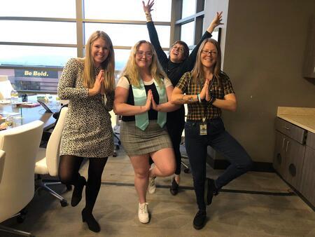 Blakeli Campbell and her committee in a "tree pose" in honor of her thesis title. From left to right: Laura Decker; Blakeli Campbell; Molly Appel; Emily Hoover (advisor)