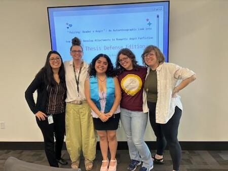Photograph of Lesly Arias wearing her honors stole, standing with her thesis committee. From left to right: Esmeralda Carretero-Rodriguez, Christine Beaudry, Lesly Arias, Rachel Herz-Betz (advisor), Molly Appel.